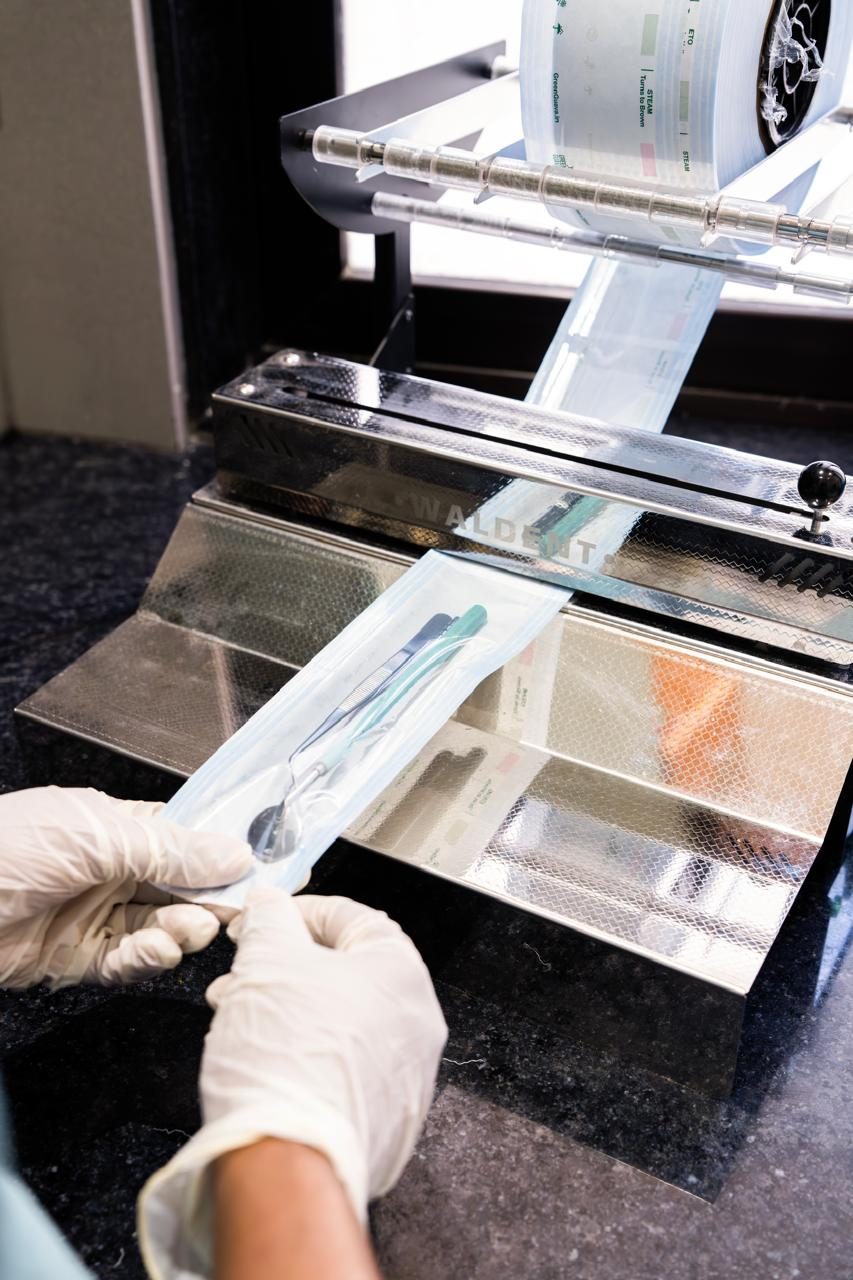 Sterilization pouch being sealed for instrument packaging