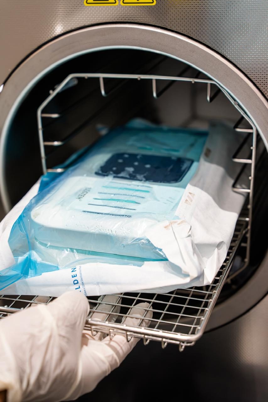 Sterilized instrument pouch being loaded into the autoclave