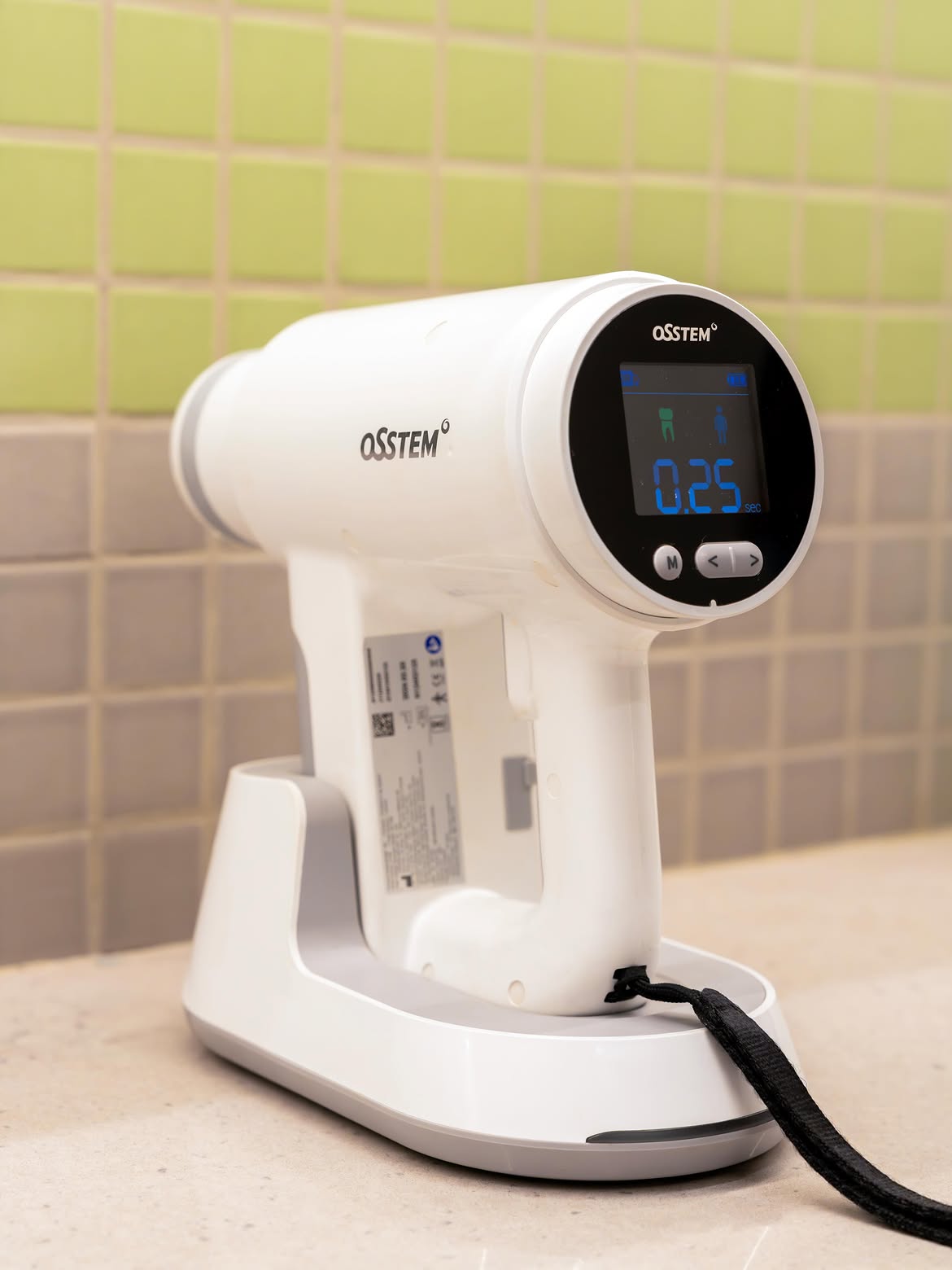 OSSTEM handheld intraoral scanner on its charging dock